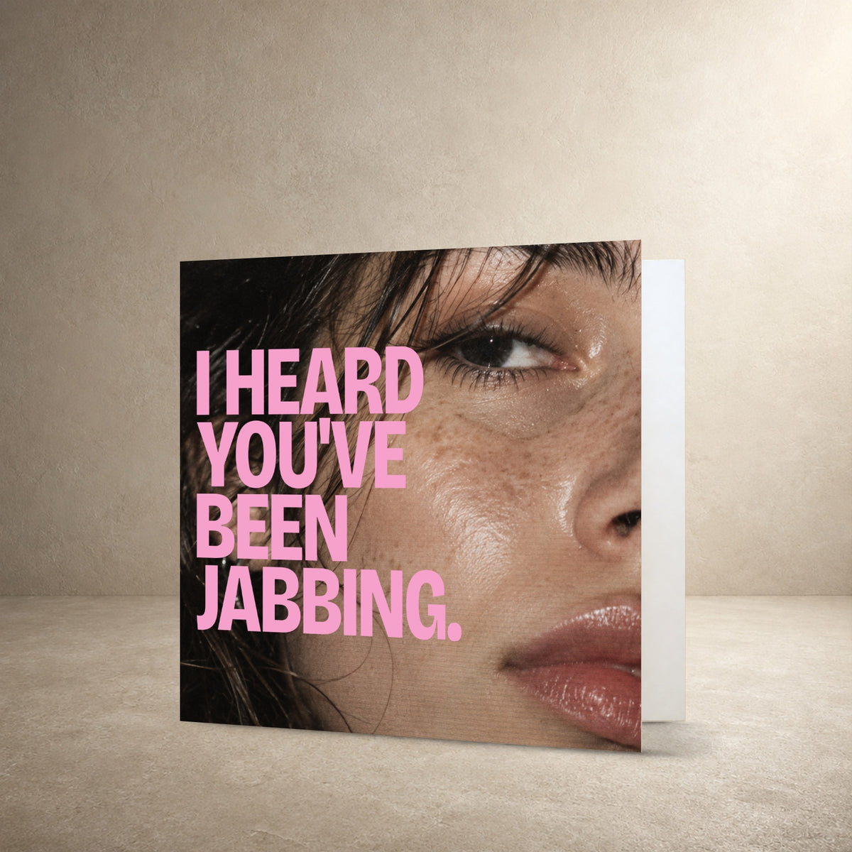 Close-up flash photograph of a face with dewy skin and dark hair, with the message: “I heard you've been jabbing.”.