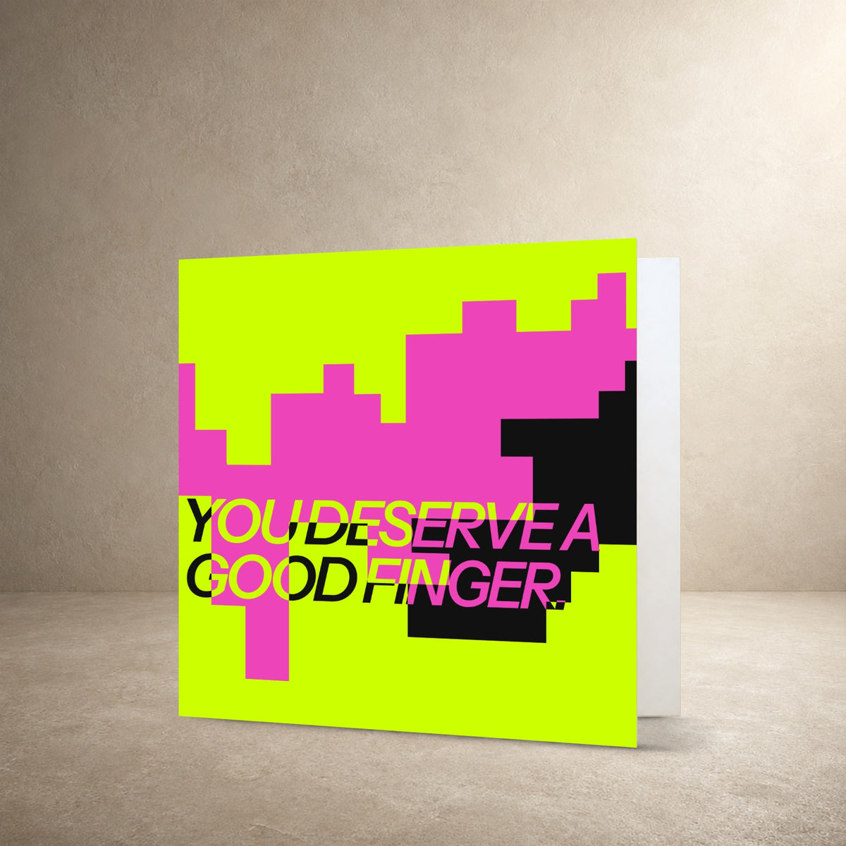 Graphic card front with stepped lime, hot pink and black colour blocks, with the message: “You deserve a good finger.”.
