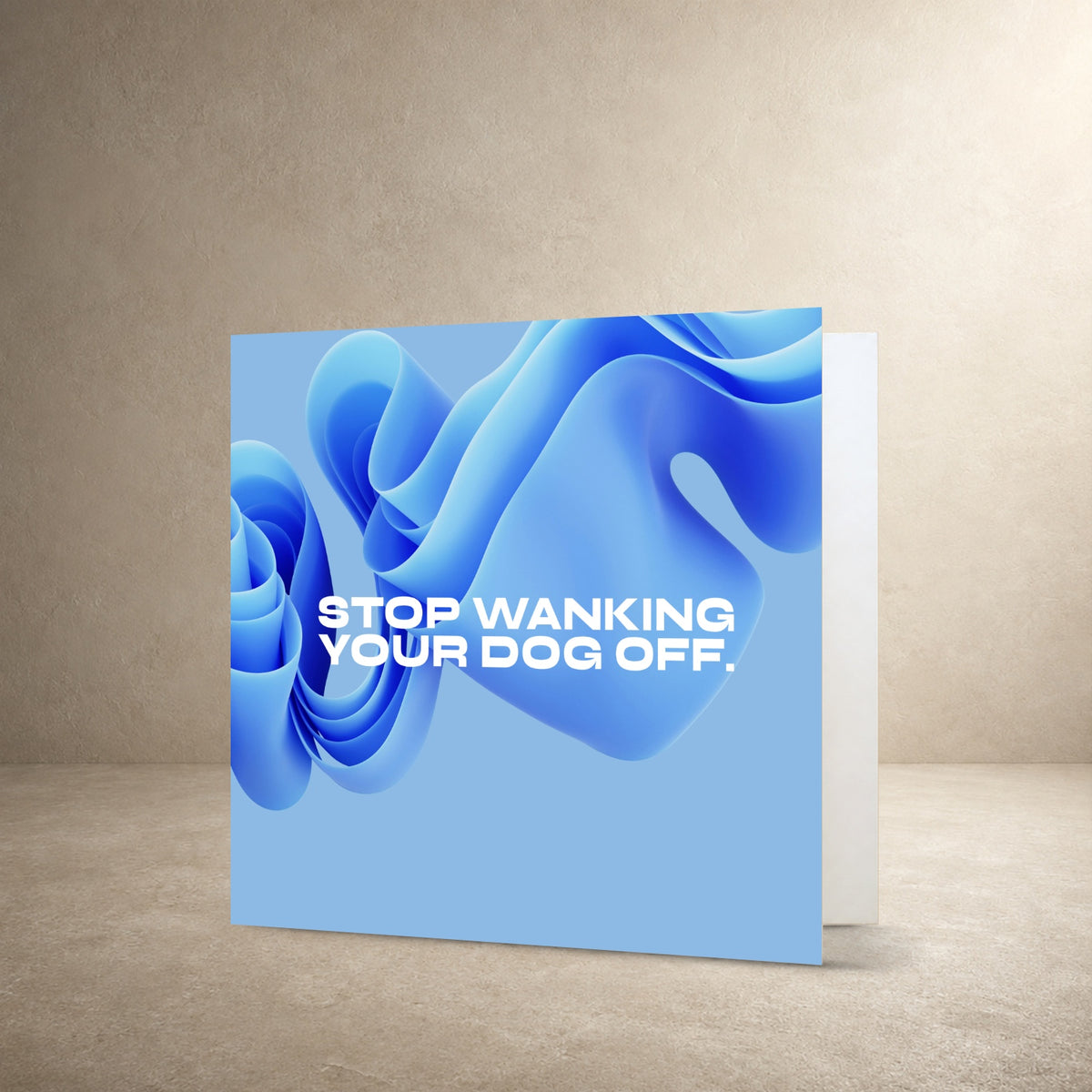 Blue card front with glossy folded abstract shapes in shades of blue, with the message: “Stop wanking your dog off.”.