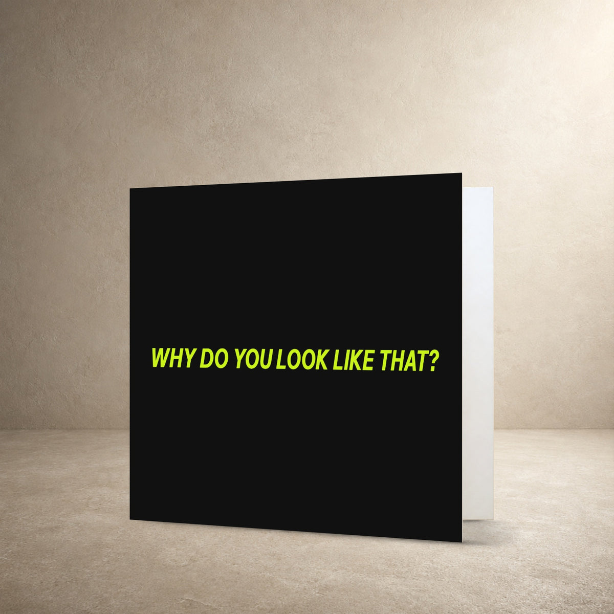 Minimal grey card front with bright lime centred typography, with the message: “Why do you look like that?”.