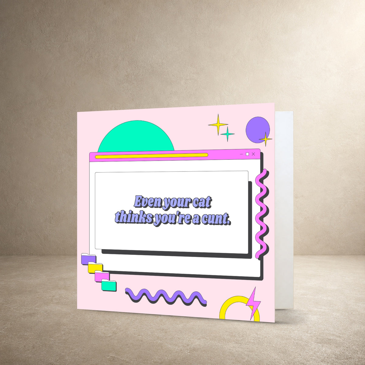 Pastel pink card front with a retro computer window, geometric shapes and squiggly graphics, with the message: “Even your cat thinks you're a cunt.”.