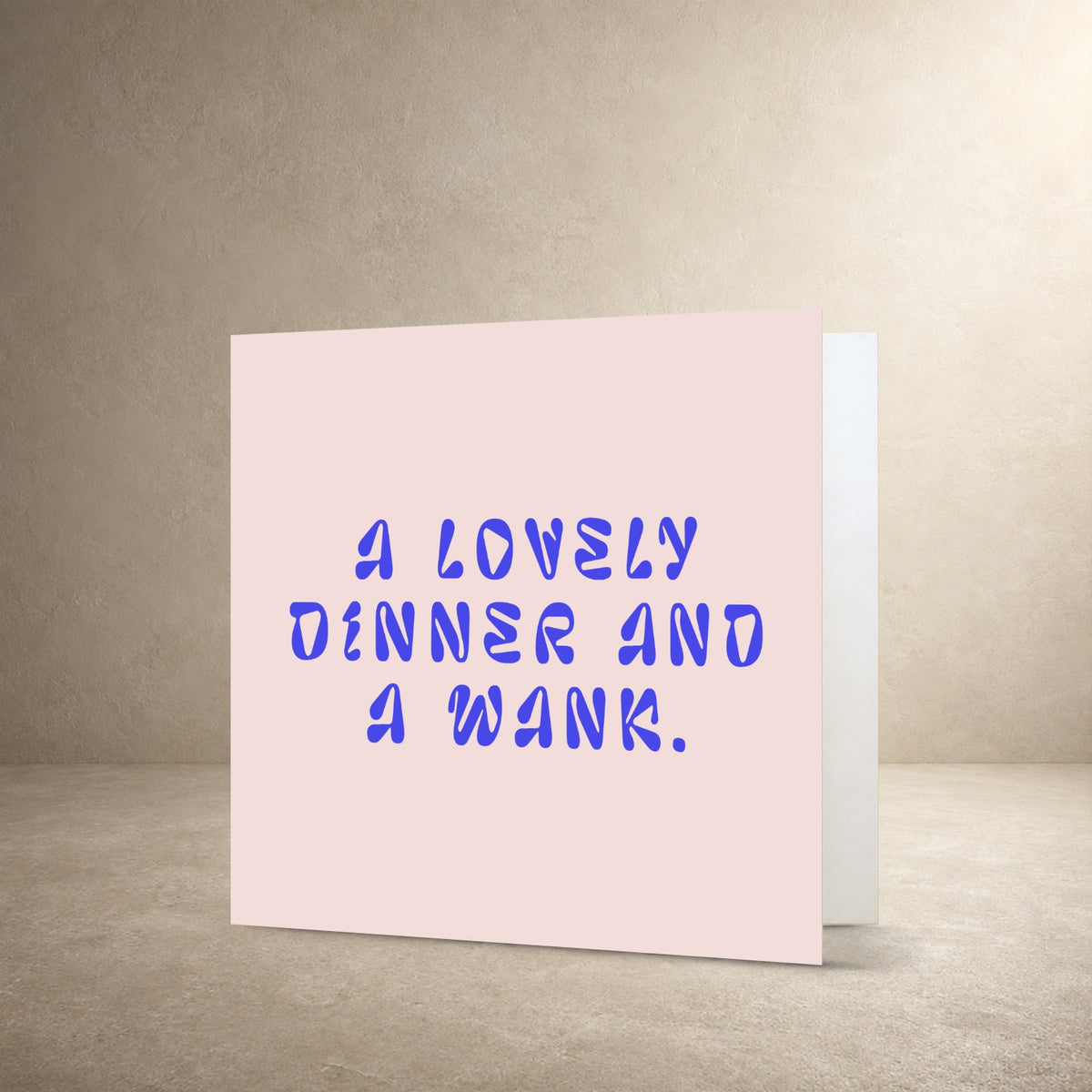 Pale pink card front with bold irregular blue typography, with the message: “A lovely dinner and a wank.”.