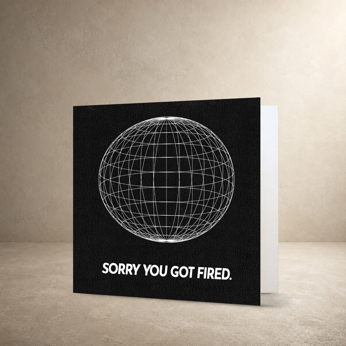 Black textured card front with a white wireframe globe, with the message: “Sorry you got fired.”.