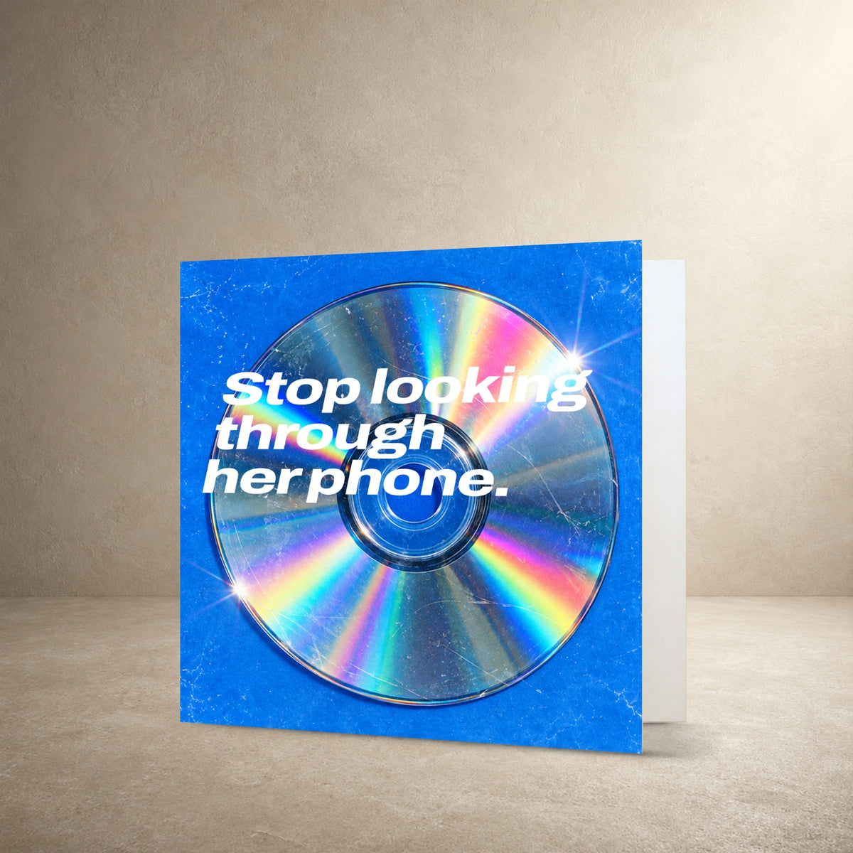 Scratched iridescent CD on a vivid blue textured background, with the message: “Stop looking through her phone.”.