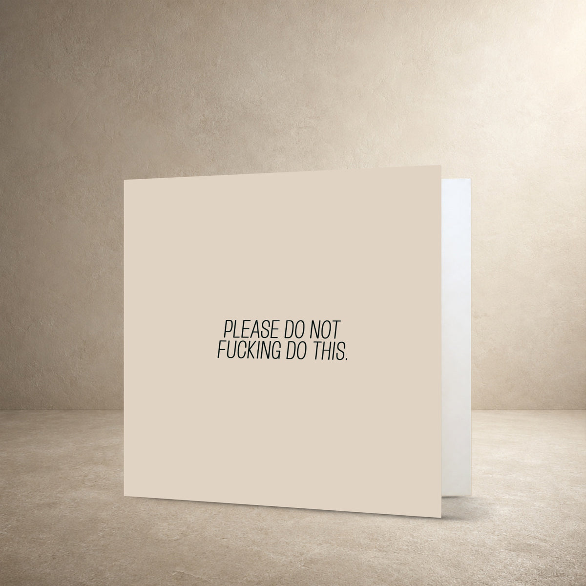 Minimal beige card front with a narrow centred typographic layout, with the message: “Please do not fucking do this.”.