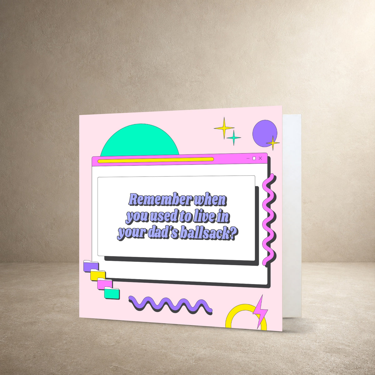Pastel pink card front with a retro computer window, geometric shapes and squiggly graphics, with the message: “Remember when you used to live in your dad's ballsack?”.
