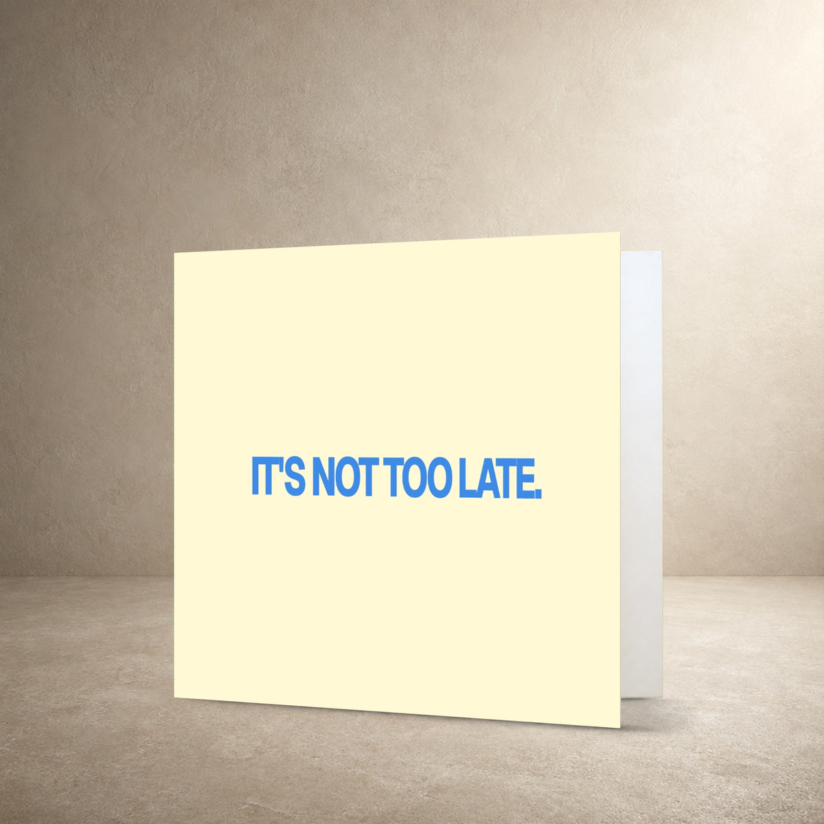 Pale cream card front with bold blue centred typography, with the message: “It's not too late.”.