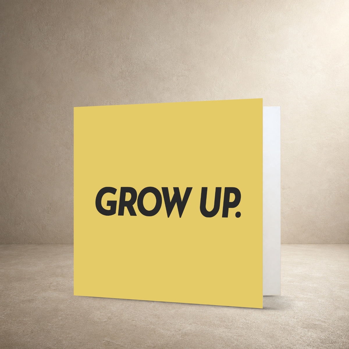 Mustard yellow card front with dark grey solid typography, with the message: “Grow up.”.